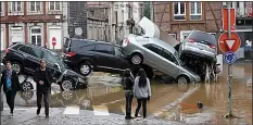  ??  ?? Chaos...roads flooded in Trier, Germany, top; cars pile up in Verviers, Belgium, above; evacuation in nearby Liege, below