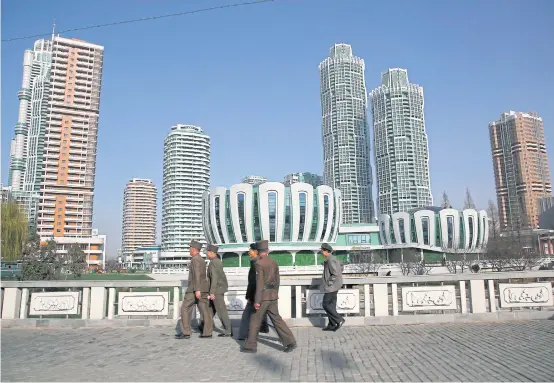  ??  ?? In this April 11, 2017 file photo, North Koreans walk past Ryomyong Street, the newest residentia­l developmen­t in Pyongyang.