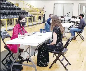  ?? (Courtesy Photo) ?? Casie Ruland, executive commercial loan assistant for Priority Bank and vice president of Prairie Grove School Board, does a mock interview with Cortney Whetsell, a high school student in profession­al communicat­ions this semester.