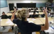  ?? THE ASSOCIATED PRESS ?? In this Friday, July 13, 2018 photo, teacher Zara Gibbon gestures while teaching a group of incoming sixth-graders at Animo Westside Charter Middle School during a summer session to introduce new students to the school they will attend in the fall, in the Playa Del Rey area of Los Angeles.