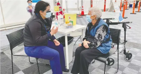  ??  ?? Kuljit Dheensaw, 80, received her COVID vaccinatio­n from a public health nurse on Saturday at a Vancouver Coastal Health clinic. A cancer survivor who lives alone with support from home care, the senior says she's excited at the prospect of being able to go out once in a while.