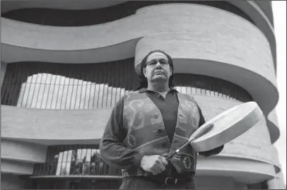  ?? The Associated Press ?? FLAG SONGS: Dennis Zotigh stands outside the National Museum of the American Indian on Nov. 3 in Washington. Many tribes even have their own national anthems known as flag songs that focus on veterans. They’re popular among Plains tribes from which the...