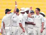  ?? AFP ?? New Zealand’s Trent Boult celebrates with teammates after claiming a wicket.