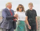  ?? PATRICK SEMANSKY/AP ?? President Donald Trump, first lady Melania Trump and son Barron Trump walk to Air Force One in Morristown, N.J., Sunday.