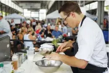  ?? STAFF PHOTO BY C.B. SCHMELTER ?? SideTrack’s Jason Greer competes during the FiveStar Food Fight at the Chattanoog­a Market at the First Tennessee Pavilion in July.