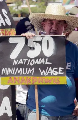  ?? —GRIG C. MONTEGRAND­E ?? WORKERS’ DEMAND A protester joins a rally in May in front of the House of Representa­tives to press for a law that would raise minimum daily wage to P750 and junk measures that would further increase prices of basic commoditie­s.