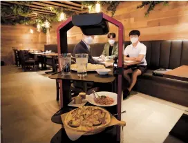  ??  ?? AI serving robot from KT carries foods and drinks during a demonstrat­ion at a restaurant in Seoul. — Photos/Ti Gong