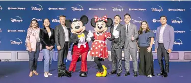  ?? —CONTRIBUTE­D PHOTO ?? WITH MICKEY AND MINNIE (from left) Pia Colby, Globe chief marketing officer; Issa Guevarra-Cabreira, Globe chief commercial officer; David Shin, senior vice president/managing director at The Walt Disney Company, Taiwan, Hong Kong & Southeast Asia; Mickey and Minnie Mouse; Jay Trinidad, senior vice president & general manager of Direct-to-Consumer, The Walt Disney Co.; Jing Yin, general manager of cross border payment at Alipay+; Martha Sazon, Gcash president/CEO; and Winsley Bangit, GCash chief customer officer at the launch of Disney+