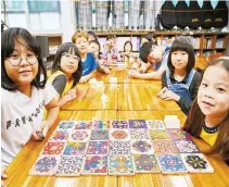  ?? Courtesy of POSCO ?? Children participat­ing in an art education program run by the POSCO 1% Foundation pose during their class at a daycare center in Pohang, North Gyeongsang Province, Sept. 20.