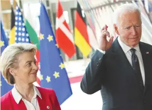  ?? (Yves Herman/Reuters) ?? US PRESIDENT Joe Biden crosses his fingers next to European Commission President Ursula von der Leyen as they attend the EU-US summit, in Brussels yesterday.