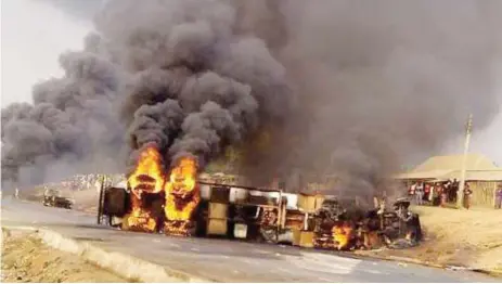  ?? Photo: Abubakar Sadiq Isah ?? The petrol tanker which caught fire burning five people to death in Gada-Biyu village, on Abuja-Lokoja road on Wednesday evening.