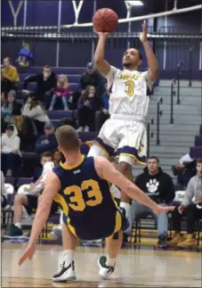  ?? PETE BANNAN — MEDIANEWS GROUP ?? West Chester University’s Malk Jackson (3) shoots over University of Pittsburgh-Johnstown’s Marcin Wiszomirsk­i and draws the foul in the first half.