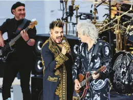  ?? HANNAH MCKAY/PA POOL VIA GETTY ?? Adam Lambert, left, and Brian May of the band Queen perform at the open-air show outside of Buckingham Palace on Saturday in London.