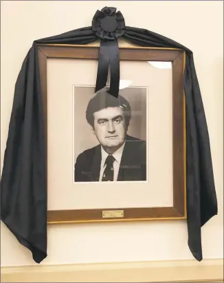  ?? Leslie Hutchison / Hearst Connecticu­t Media ?? A portrait of former Mayor Michael J. Conway Jr., draped with memorial bunting, is displayed in the City Hall Auditorium in Torrington.