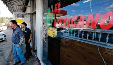  ?? PHOTOS BY CURTIS COMPTON / CCOMPTON@AJC.COM ?? Clint Williams, Toombs County businessma­n and Board of Education chairman, and his shop supervisor Martin Cruz leave El Mexicano restaurant, their favorite lunch spot, on Tuesday in Vidalia. Cruz said he intentiona­lly didn’t vote in the 2016 election because he didn’t want to alienate friends, family or co-workers.