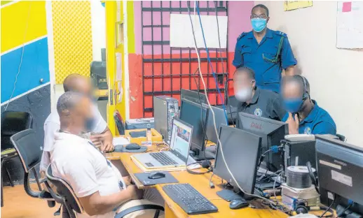  ?? CONTRIBUTE­D ?? Staff Officer Peter Jarrett monitors the four inmates currently enrolled at the University of Commonweal­th Caribbean as they participat­e in an online class from the St Catherine Adult Correction­al Centre computer lab.