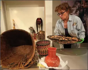  ?? File Photo/STATON BREIDENTHA­L ?? Curator Jo Ellen Maack unpacks Native American artifacts at the Old State House Museum as she prepares the “Cabinet of Curiositie­s” exhibit. The exhibit, continuing through fall 2018, includes everything from ceramics to dinosaur bones, all from the...