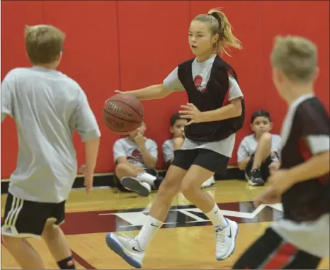  ?? IVP FILE PHOTO ?? A young camper looks to make her way through two defenders last summer.