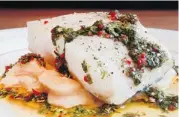  ??  ?? Roast ling cod shows chef Dammann at his best. Perfectly cooked, the fish is placed on a bed of braised lima beans and served with a salsa verde made with mint and coriander.