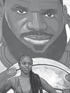  ?? MIKE CARDEW/AKRON BEACON JOURNAL ?? Chardae Slater talks in July about Lebron James and her mural in Akron.