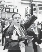  ?? JUSTIN LANE/EPA-EFE ?? Wall Street investors saw the Dow surge more than 545 points Wednesday.