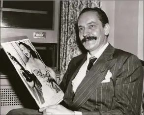  ?? Albany Times Union Historic Images ?? Frederic March, named Hollywood’s best actor of 1946, is in a happy mood as he holds a photo of Olivia De Havilland holding her Oscar after she was named best actress of 1946.