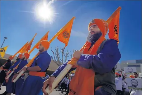  ?? Photograph­s by Francine Orr
Los Angeles Times ?? MEMBERS OF THE SIKH community gathered Saturday for a march to mark the 31st anniversar­y of a rampage against Sikhs in India. Above, Manmeet Singh, 19, of Riverside participat­es in the march from the Beverly Center to the Los Angeles Museum of the...