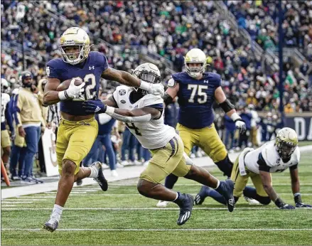  ?? DARRON CUMMINGS/ASSOCIATED PRESS ?? Notre Dame’s Logan Diggs runs past Tech’s Quez Jackson for one of his two touchdowns Saturday. The Irish hit their scoring high for the season against the Yellow Jackets, whose defense was shredded once again.