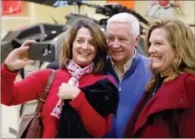  ?? THE ASSOCIATED PRESS ?? Pennsylvan­ia Republican Gov. Tom Corbett, who is seeking a second term, poses for a selfie with supporters during a campaign rally Monday, at the American Helicopter Museum in West Goshen.