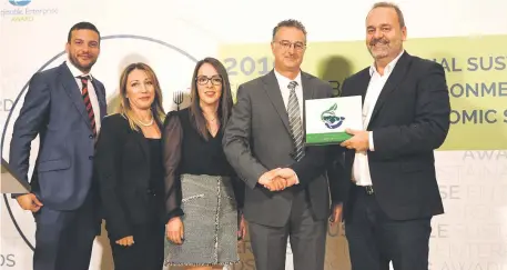  ??  ?? GreenPak CEO Ing Mario Schembri receiving the first overall trophy from Minister Chris Cardona in the presence of GreenPak’s team. From left: Daniel Tabone, Denise Brincat and Christine Demanuele