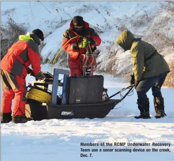 ??  ?? Members of the RCMP Underwater Recovery Team use a sonar scanning device on the creek, Dec. 7.