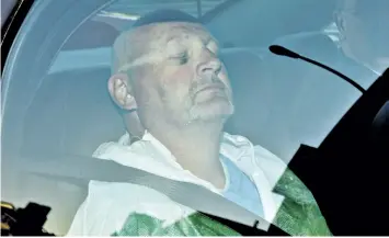  ?? PHIL CARPENTER/THE GAZETTE ?? Richard Henry Bain sits with his eyes closed in the back of a police car, as he arrives at the Montreal courthouse in Montreal in 2012. On Tuesday, Bain was found guilty of second-degree murder in the death of a lighting technician and found him guilty...