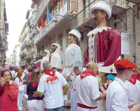  ??  ?? Four-meter-tall giants and large-headed puppets called Gigantes y Cabezudos travel through the city during the festival, parade and dance to music. These four pairs of kings and queens of di erent races are 150 years old.