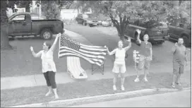  ?? JACQUELYN MARTIN/ASSOCIATED PRESS ?? People wave at the presidenti­al motorcade as President Barack Obama approaches the Women’s Right National Historic Park Visitor’s Center in Seneca Falls, N.Y., on Thursday, the first day of a two- day bus tour where Obama is speaking about college...