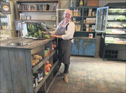  ?? TANIA BARRICKLO — DAILY FREEMAN ?? Chris Jacobs, who co-owns The Amsterdam restaurant in Rhinebeck, N.Y. with her husband Howard stands among new features of their restaurant, including fresh produce and gourmet foods.