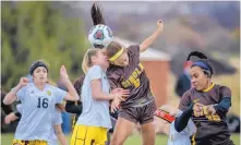  ?? ROBERTO E. ROSALES/JOURNAL ?? Centennial’s Abbie Dickens, center left, battles Cibola’s Emily Aguilar, center right, for possession late in the second overtime of their Class 5A girls semifinal Thursday.