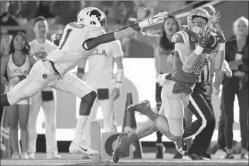  ?? Photograph­s by Kelvin Kuo Associated Press ?? UCLA RECEIVER Ethan Fernea hauls in a 45-yard touchdown pass behind Colorado’s Delrick Abrams Jr.