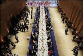  ??  ?? In this July 7, 2017 photo, the heads of government of the G-20 states and their partners have dinner after a concert in the Elbphilhar­monie concert hall in Hamburg, Germany