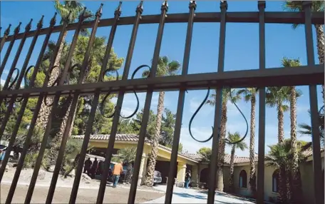  ?? Photog raphs by Isacc Brekken For The Times ?? THE BLACK METAL GATES of a Las Vegas mansion attracted thrill seekers after the home was featured on “Ghost Adventures.”