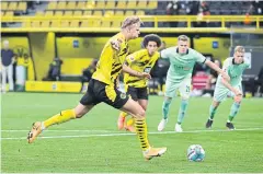  ?? AFP ?? Borussia Dortmund’s Erling Braut Haaland scores a penalty against Borussia Moenchengl­adbach.