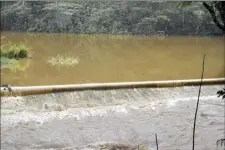  ?? The Maui News / MATTHEW THAYER photos ?? According to a state report, the Kaupakalua Dam was in “unsatisfac­tory” overall condition before the flood hit, and a plan was underway to remove the dam this summer.