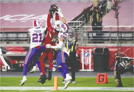  ?? CHRISTIAN PETERSEN/GETTY IMAGES ?? Arizona Cardinals wide receiver DeAndre Hopkins catches the game-winning touchdown pass with only two seconds remaining in the game in front of Buffalo Bills safety Jordan Poyer and safety Micah Hyde at State Farm Stadium in Glendale, Arizona.