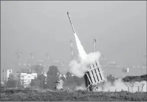  ?? AP/ARIEL SCHALIT ?? A rocket is launched from the Israeli anti-missile system in Ashdod, Israel, to stop a rocket fired by Palestinia­n militants from the Gaza Strip on Sunday.