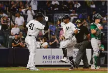  ?? Jim McIsaac / Getty Images ?? Rougned Odor (right) of the Yankees celebrates his home run against the A’s with Miguel Andujar in New York in June.