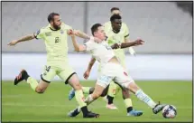  ?? (AP) ?? Marseille’s Florian Thauvin, (center), Dijon’s Jordan Marie, (left), and Mama Balde fight for the ball during the French League One soccer match between Marseille and Dijon at the Stade Veledrome Stadium in Marseille, France, on April 4.