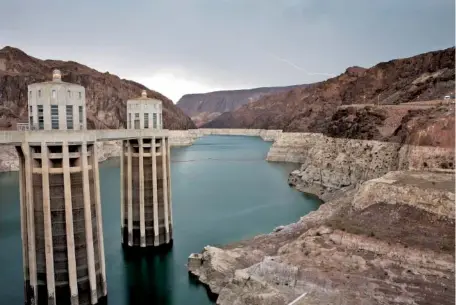  ?? AP PHOTO/JOHN LOCHER ?? Lightning strikes over Lake Mead in 2014 near the Hoover Dam that impounds Colorado River water at the Lake Mead National Recreation Area in Arizona.