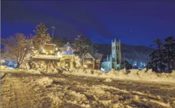  ?? PTI ?? A view of a snow-covered road following heavy snowfall at the Ridge in Shimla on Friday.