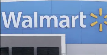  ?? AP PHOTO/STEVEN SENNE ?? In this Sept. 3 file photo, a Walmart logo is displayed outside of a Walmart store, in Walpole, Mass.