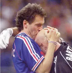  ??  ?? File photo of French Laurent Blanc kissing the head of goalkeeper Fabien Barthez at the Stade de France in Saint-Denis, near Paris after France defeated Brazil 3-0 in the 1998 World Cup final. — AFP photo