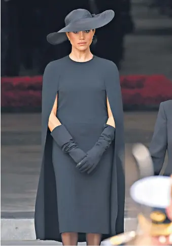  ?? ?? Simply stylish The Duchess of Sussex, below, chose a cape dress by Stella Mccartney, and a Stephen Jones for Dior hat